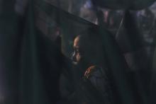 A woman displaced by the fighting in Bor county sits by her mosquito net in the early morning in Minkaman, in Awerial county, Lakes state, in South Sudan, January 15, 2014. PHOTO BY REUTERS/Andreea Campeanu