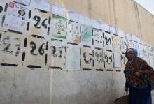 A woman walks past parliamentary election posters in Kasserine, October 23, 2014. PHOTO BY REUTERS/Zoubeir Souissi