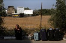 A woman waits for a travel permit to cross into Egypt through the Rafah border crossing after it was opened by Egyptian authorities on Wednesday for five days, in the southern Gaza Strip, June 30, 2016. PHOTO BY REUTERS/Ibraheem Abu Mustafa