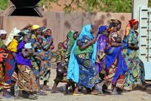 Rural women who have carried their malnourished children for days across the Sahel desert in search of [food] rush into an emergency feeding center in the town of Guidan Roumdji, southern Niger, July 1, 2005. PHOTO BY REUTERS