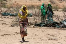 An internally displaced woman walks through a camp on the outskirts of the town of Qol Ujeed, on the border with Ethiopia, Somaliland, April 17, 2016. PHOTO BY REUTERS/Siegfried Modola