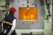 A worker looks through a thick glass window at part of the treatment of nuclear waste at the Areva Nuclear Plant of La Hague, near Cherbourg, western France, April 22, 2015. PHOTO BY REUTERS/Benoit Tessier