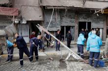 Municipality workers clean up a street in front of a building which was hit by rockets fired from Syria, in the border town of Reyhanli in Hatay province, Turkey, January 22, 2018. PHOTO BY REUTERS/Umit Bektas