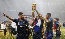 France's Corentin Tolisso, Presnel Kimpembe and Olivier Giroud celebrate with the trophy after winning the World Cup. PHOTO BY REUTERS/Carl Recine