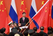 Chinese President Xi Jinping (C) looks on as Chinese soldiers carry the Chinese flag during a medal presentation ceremony in the Great Hall of the People in Beijing, China, June 8, 2018. PHOTO BY REUTERS/Greg Baker