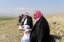 Yazidi refugees talk on a hill overlooking their refugee camp on the outskirts of Duhok, February 26, 2015. PHOTO BY REUTERS/Asmaa Waguih