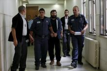 Yosef Haim Ben-David (C), who was convicted of murdering a Palestinian teenager in Jerusalem, is led out of the courtroom by Israeli prison guards at Jerusalem's District Court, April 19, 2016. PHOTO BY REUTERS/Ammar Awad