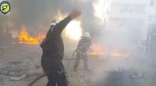 A still image taken from a video uploaded by White Helmets on June 24, 2017, shows civil defence members trying to put out a fire at the site of a car bomb, said to be in the town of al-Dana, in Syria's rebel-held Idlib province. PHOTO BY REUTERS/White Helmets