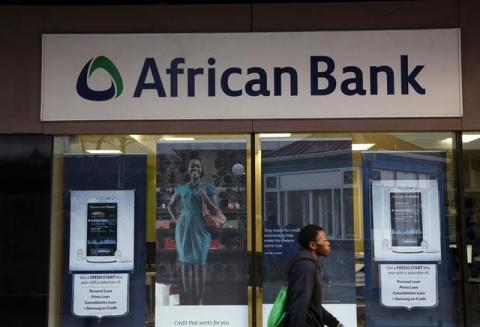 A man walks past a branch of African Bank in Cape Town, August 8, 2014. PHOTO BY REUTERS/Mike Hutchings