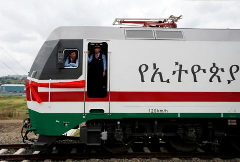 Chinese train masters look out from a train as they wait for passengers during the inauguration of the new train line linking Addis Ababa to the Red Sea state of Djibouti, in Addis Ababa, Ethiopia, October 5, 2016. PHOTO BY REUTERS/Tiksa Negeri