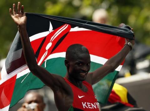 Kenya's Abel Kirui celebrates with his national flag after winning the silver in the men's marathon in the London 2012 Olympic Games at The Mall, August 12, 2012. PHOTO BY REUTERS/Stefan Wermuth