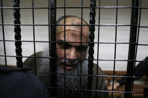 Radical Muslim cleric Abu Qatada speaks to the media after he was acquitted at the State Security Court in Amman