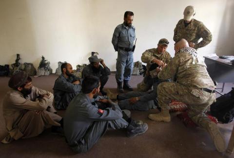 U.S. military advisors for NATO Training Mission-Afghanistan (NTM-A) conduct Combat First Aid lessons with Afghan policemen inside a police station in Khas Konar district in Kunar province, eastern Afghanistan