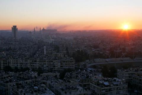 The sun rises while smoke is pictured near Aleppo's historic citadel, as seen from a government-controlled area of Aleppo, Syria, December 6, 2016. PHOTO BY REUTERS/Omar Sanadiki
