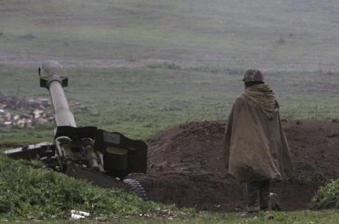 An Armenian soldier of the self-defense army of Nagorno-Karabakh stands near an artillery unit in the town of Martakert, where clashes with Azeri forces are taking place, in Nagorno-Karabakh region, which is controlled by separatist Armenians, April 3, 2016. PHOTO BY REUTERS/Vahram Baghdasaryan