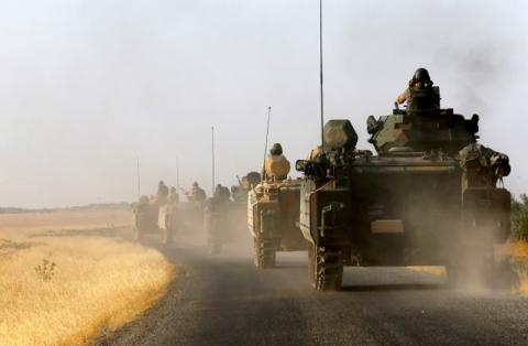 Turkish armoured personnel carriers are driven towards the border in Karkamis on the Turkish-Syrian border in the southeastern Gaziantep province, Turkey, August 27, 2016. REUTERS/Umit Bektas