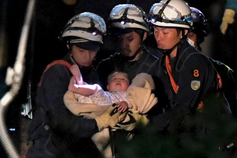 An eight-month-old baby is carried away by rescue workers after being rescued from her collapsed home following an earthquake in Mashiki town, Kumamoto prefecture, southern, Japan. PHOTO BY REUTERS/Daisuke Wada