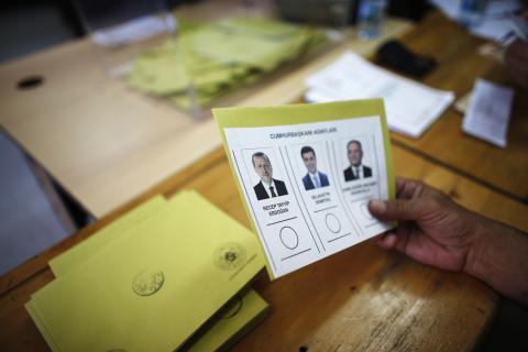 A polling station official holds a ballot paper in Turkey's first direct presidential elections at a polling station in Ankara