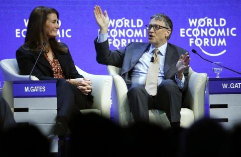 Bill Gates, Co-Chair of the Bill & Melinda Gates Foundation gestures next to his wife Melinda French Gates during the session 'Sustainable Development: A Vision for the Future' in the Swiss mountain resort of Davos, January 23, 2015. PHOTO BY REUTERS/Ruben Sprich