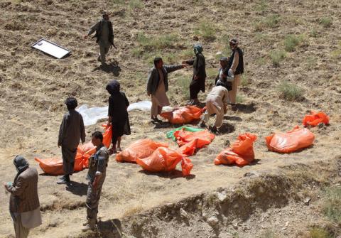 Villagers collect the dead bodies of civilians who were killed by insurgents at Mirza Olang village, in Sar-e Pul province, Afghanistan, August 15, 2017. PHOTO BY REUTERS/Stringer