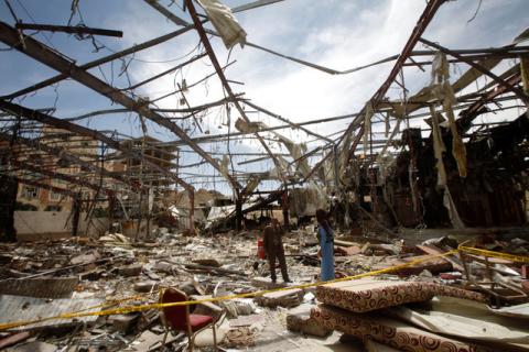 Member of the Specialized Criminal Prosecution Rajeh Zayed (L) responds to a call during a visit by human rights activists to a community hall that was struck by an air strike during a funeral on October 8, in Sanaa, Yemen, October 16, 2016. PHOTO BY REUTERS/Mohamed al-Sayaghi
