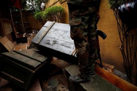 Mutinying soldiers stand next to a box full of weapons found after an investigation at a residence of a civilian in Bouake, Ivory Coast, May 15, 2017. PHOTO BY REUTERS/Luc Gnago