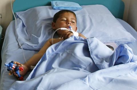 A boy receives treatment at a military hospital in Kabul, after being wounded during a suicide attack at a volleyball match on Sunday in the Yahya Khail district of Paktika province, November 24, 2014. PHOTO BY REUTERS/Mohammad Ishaq
