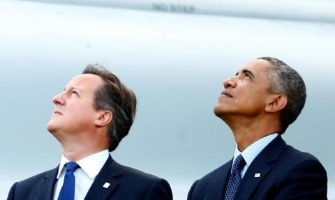 Prime Minister David Cameron and President Barack Obama watch a fly-past by the Red Arrows during a 2014 NATO summit in Wales. PHOTO BY REUTERS/Andrew Winning