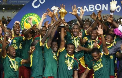 Cameroon's Benjamin Moukandjo celebrates with the trophy and teammates after winning the African Cup of Nations. PHOTO BY REUTERS/Mike Hutchings Livepic