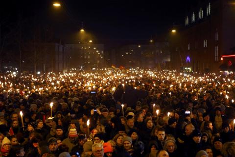 People hold candles during a memorial service is held for those killed on Saturday by a 22-year-old gunman, in Copenhagen, February 16, 2015. PHOTO BY REUTERS/Leonhard Foeger