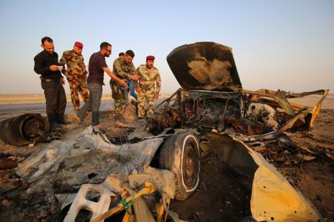 Iraqi security forces inspect the site of a bomb attack at a police checkpoint on a highway near the southern Iraqi city of Nassiriya, Iraq, September 14, 2017. PHOTO BY REUTERS/Essam Al-Sudani