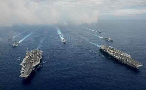 The Nimitz-class aircraft carriers USS John C. Stennis (CVN 74), and USS Ronald Reagan (CVN 76) (R) conduct dual aircraft carrier strike group operations in the U.S. 7th Fleet area of operations in support of security and stability in the Indo-Asia-Pacific in the Philippine Sea, June 18, 2016. PHOTO BY REUTERS/Jake Greenberg