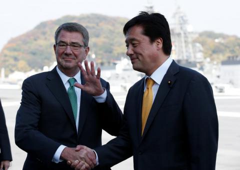 U.S. Defense Secretary Ash Carter (L) shakes hands with Japan's vice Minister of Defense Kenji Wakamiya on the deck of the Izumo, Japan Maritime Self Defense Force's (JMSDF) helicopter carrier, at JMSDF Yokosuka base in Yokosuka, south of Tokyo, Japan, December 6, 2016. PHOTO BY REUTERS/Kim Kyung-Hoon