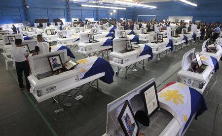 Caskets of slain members of the Special Action Force (SAF) who were killed in Sunday's clash with Muslim rebels are seen during a service inside a police headquarters in Taguig city, south of Manila, January 30, 2015. PHOTO BY REUTERS/Romeo Ranoco