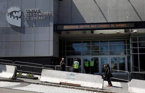 Police officers stand near the Congress Center prior to the beginning of the G7 Summit in Quebec City, June 6, 2018. PHOTO BY REUTERS/Mathieu Belanger