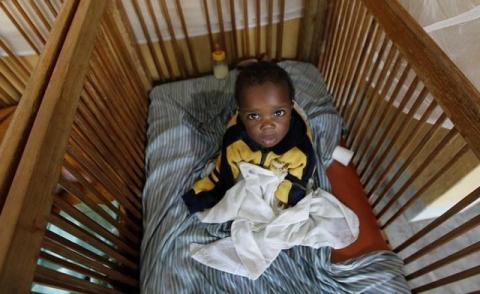 Michelle Sodiki, an abandoned child, rests in his cot at the Don Bosco Ngangi community center in Goma, North Kivu region, August 6, 2013. PHOTO BY REUTERS/Thomas Mukoya