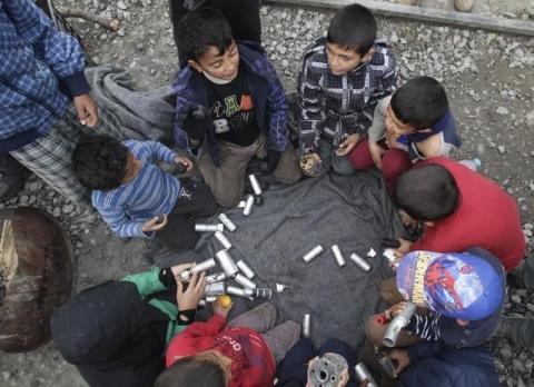 Migrant children play with rubber bullets and empty cases at a makeshift camp for refugees and migrants at the Greek-Macedonian border near the village of Idomeni, Greece, April 11, 2016. PHOTO BY REUTERS/Alexandros Avramidis