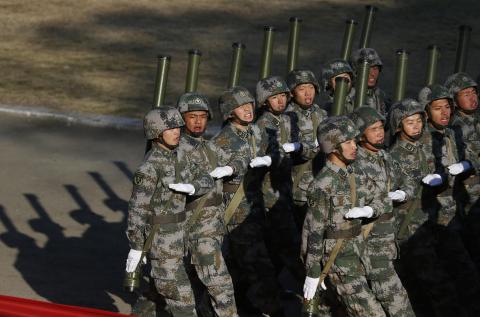 Soldiers of the Chinese People's Liberation Army march during their drill ahead of their year-end review in Jiaxing, Zhejiang province