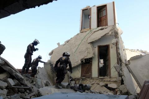 Civil Defence members inspect a damaged site after an airstrike in the besieged rebel-held al-Qaterji neighbourhood of Aleppo, Syria, October 14, 2016. PHOTO BY REUTERS/Abdalrhman Ismail