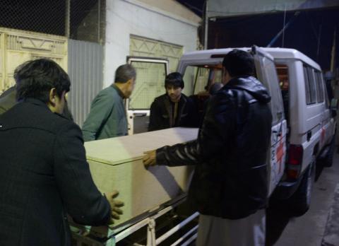 Afghan men unload a coffin of an International Committee of the Red Cross (ICRC) employee, who was killed by gunmen in Jwzjan province, at a hospital in Mazar-i-Sharif, Afghanistan February 8, 2017. PHOTO BY REUTERS/Stringer