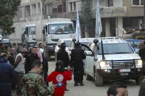 A United Nations and Syrian Arab Red Crescent aid convoy is seen along a street in Homs city, February 8,2014, in this handout released by Syria's national news agency SANA