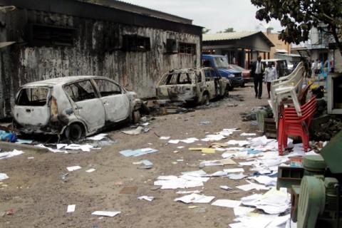 Congolese civilians walk past a house and vehicles which were burnt during anti-government protests to press President Joseph Kabila to step down in the Democratic Republic of Congo's capital Kinshasa, September 21, 2016. PHOTO BY REUTERS/Kenny Katombe