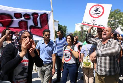 People demonstrate against a bill that would protect from prosecution those accused of corruption, in front of Assembly of the Representatives of the People in Tunis, Tunisia September 13, 2017. The sign reads: "No. We will not forgive". PHOTO BY REUTERS/Zoubeir Souissi