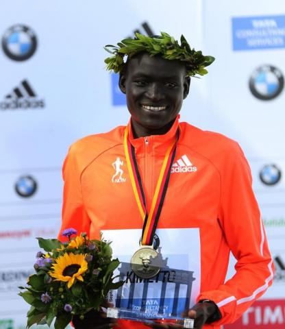 Dennis Kimetto of Kenya holds his trophy as he celebrates during the awards ceremony for the 41st Berlin marathon