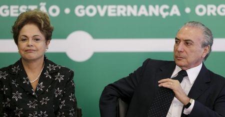Brazil's President Dilma Rousseff (L) reacts next to Vice President Michel Temer during a ceremony to announce measures to modernize Brazilian soccer at the Planalto Palace in Brasilia, March 19, 2015. PHOTO BY REUTERS/Ueslei Marcelino