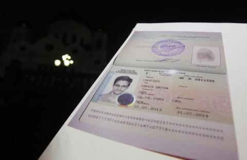 Fugitive former U.S. spy agency contractor Edward Snowden's refugee documents granted by Russia is seen during a news conference in Moscow