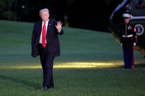U.S. President Donald Trump waves as walks on the South Lawn of the White House upon his return to Washington, U.S., from the G20 Summit in Hamburg, July 8, 2017. PHOTO BY REUTERS/Yuri Gripas