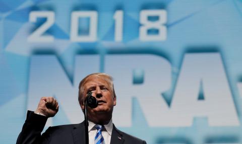 President Donald Trump makes a fist as he addresses the National Rifle Association (NRA) Convention in Dallas, Texas, May 4, 2018. PHOTO BY REUTERS/Carlos Barria