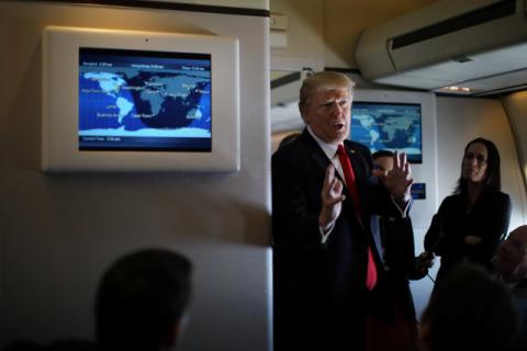 U.S. President Donald Trump talks to journalists members of the travel pool on board the Air Force One during his trip to Palm Beach, Florida while flying over South Carolina, U.S., February 3, 2017. PHOTO BY REUTERS/Carlos Barria