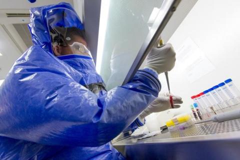 Doctor for tropical medicine Florian Steiner demonstrates the testing of a blood sample at the quarantine station for patients with infectious diseases at the Charite hospital in Berlin, August 11, 2014. PHOTO BY REUTERS/Thomas Peter